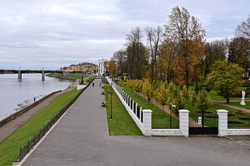Beautiful city landscape with view of embankment, river and bridge over it. , Autumn park with yellow trees. Concept of tourism and recreation. Tver. Russia