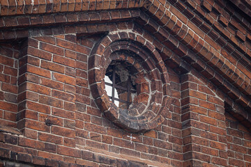 Round window in an old brick wall