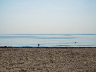 Fototapeta na wymiar Spanish beach along the Mediterranean sea with people bathing