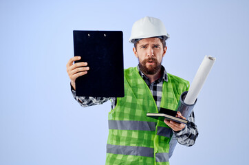 male builder in a white helmet blueprints Professional blue background