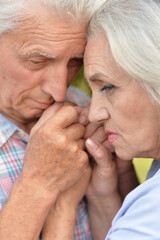 Portrait of unhappy senior couple in the park