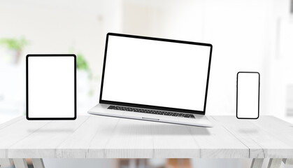 Laptop, tablet and phone with isolated display for mockup, levitating above the desk. Creative responsive design promotion concept