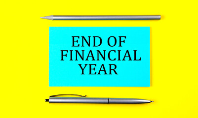 text END OF FINANCIAL YEAR on the blue sticker on the yellow background