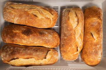 Top view Fresh loaves of artisan hot bread. Delicious and healthy food from small bakeries