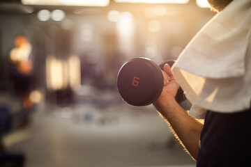 fit young man in sportswear trainings in a gym healthy active lifestyle