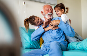Little girls visiting grandfather in hospital, who is recovering from coronavirus.
