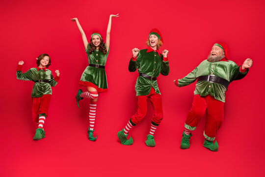 Full size photo of positive cheerful santa helper elf dance xmas holiday spirit miracle isolated on red color background