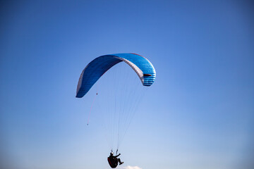 glider paragliding g against blue sky flying  adrenaline and freedom concept