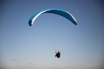 Naklejka na ściany i meble glider paragliding g against blue sky flying adrenaline and freedom concept