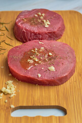 Close up of fresh raw tuna steaks on wood. Top View