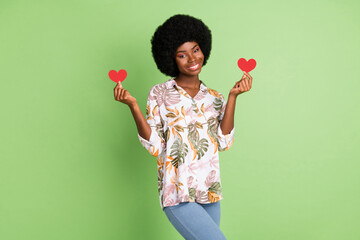 Photo of young afro girl happy positive smile hold little paper heart feelings date romantic isolated over green color background