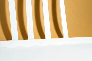 Creative layout of geometric white lines with hard shadows on a white beige background in the rays of the sun. Minimal background concept for a product, for summer or autumn