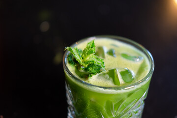 matcha cocktail or tea or latte with ice and mint isolated on black background. modern drinks....