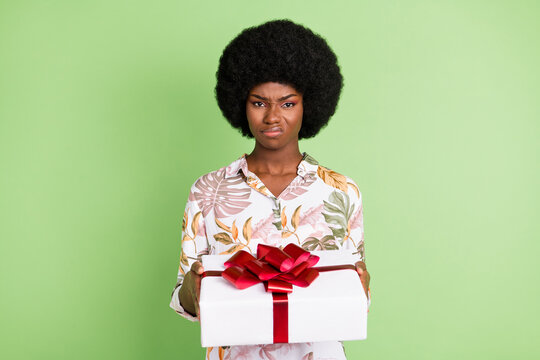 Photo Of Young Afro Girl Unhappy Sad Upset Dislike Present Gift Box Isolated Over Green Color Background