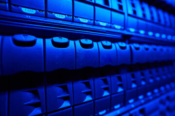 Picture of hard drives in dark room with blue neon light