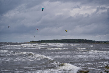 Kitesurfer jumping high on a cloudy day with big waves at Gronhogen, Oland, Sweden
