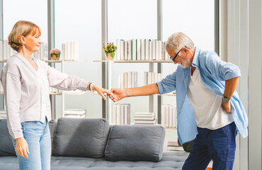 Obraz premium Portrait of happy senior couple dancing in living room, Elderly woman and a man dancing, Happy family concepts