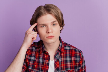 Portrait of smart clever genius geek guy finger temple advertise college on violet background