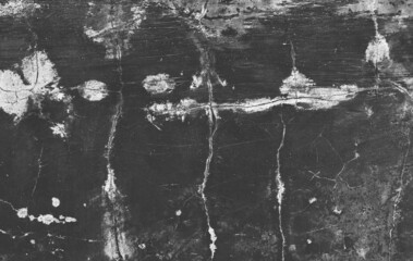 Dark gray cracks and wrinkled creases on old grainy paper in black