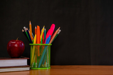 stationery box on brown table on black background