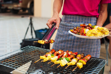 The chef is preparing food and barbecue for the party at home.