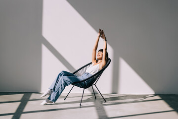 Young pretty woman resting in lounge chair at home