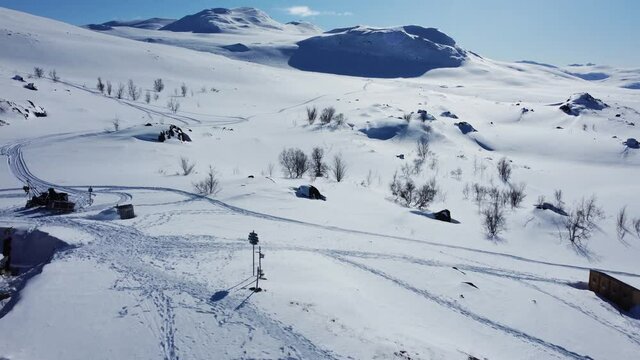 Mountain Cabins In Frosty Landscape - STF Unna Allakas In Kiruna, Sweden - aerial drone shot