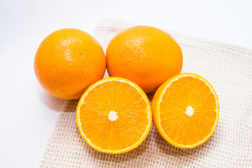Oranges on white background, oranges cut in half