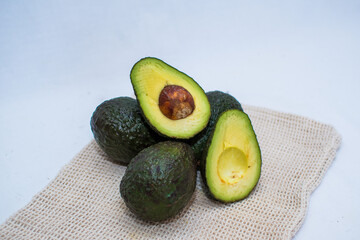 concept of avocados on an infinite background, avocado cut in half with the pit
