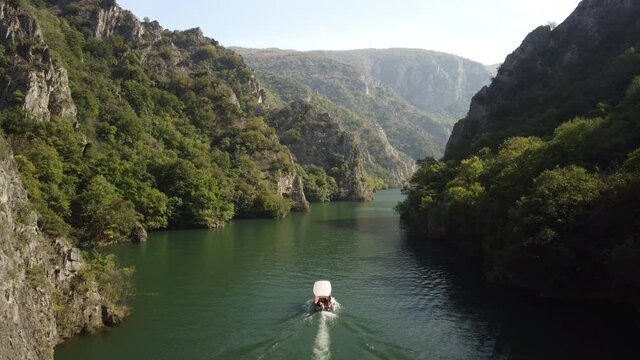 Matka Canyon, Macedonia, boat sailing through rocks, footprints on the water