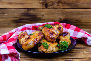 Pile of the roasted chicken wings on plate