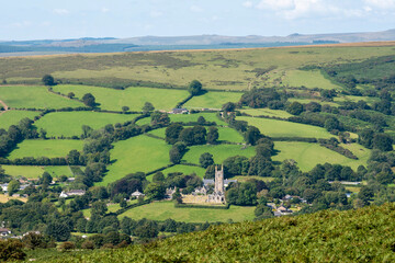 Widecombe in the Moor, Dartmoor, Devon, England, UK. 2021.  The church of St Pancras also known as Cathedral of the Moors with a backdrop of Dartmoor, Devon, UK.