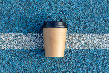 a blank coffee cup on the running track start line