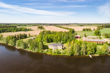 Kouvola, Finland - June 3, 2021: Aerial view of beautiful wooden Rabbelugn Manor - Takamaan Kartano. River Kymijoki bank.