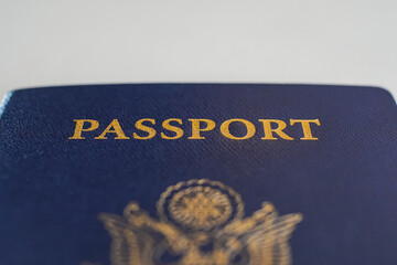 a blue passport on a desk