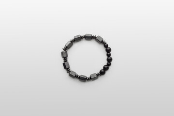 Silver stone bracelet on white board. White Table