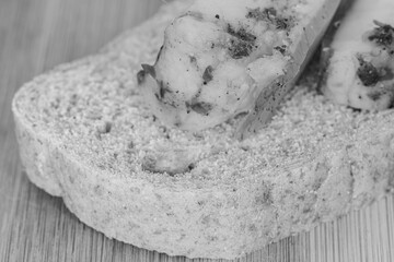  a piece of bread with a piece of lard macro in black and white