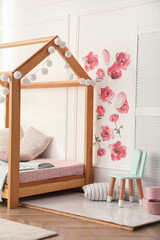 Fototapeta na wymiar Stylish child room interior with wooden house bed