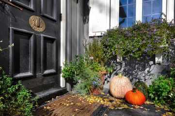 Pumpkin decoration on the front door of a house in autumn