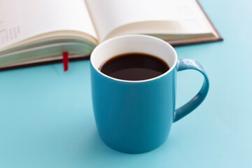 Blue ceramic cup with black coffee