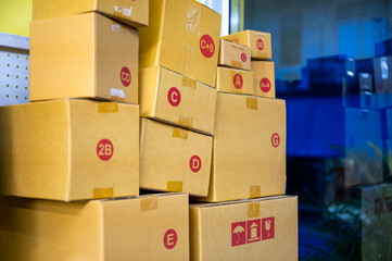Different sizes brown cardboard box stacked in delivery shop