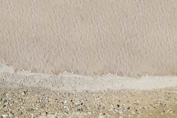 Top and aerial view on tropical sand beach with pebbles. Drone photo. Background