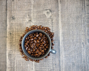 grains of black coffee, gray crumbs stand on a wooden table. top view