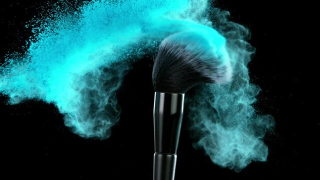 Super slow motion of makeup brush with exploding blue powder. Filmed on high speed cinema camera, 1000fps.