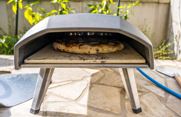 Making home made pizza in portable high temperature pizza oven. 