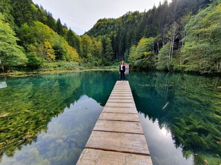 Beautiful girl on a wooden landing stage in Austria