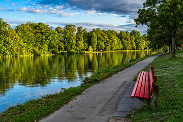 Red benches on the long Danube river in Ulm. Ulm, Tübingen, Donau-Iller region, Germany, Europe