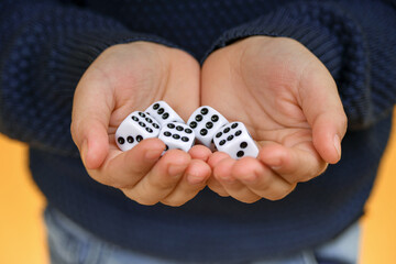 The dice are in the hand of the person offering to play the dice.