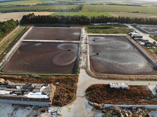 Basin or tank sedimentation tanks. Aerial top view of round polls in wastewater treatment plant, filtration of dirty or sewage water. - obrazy, fototapety, plakaty