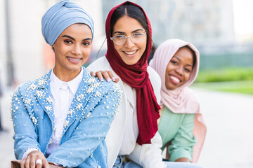 Beautiful muslim girl wearing hijab bonding outdoors